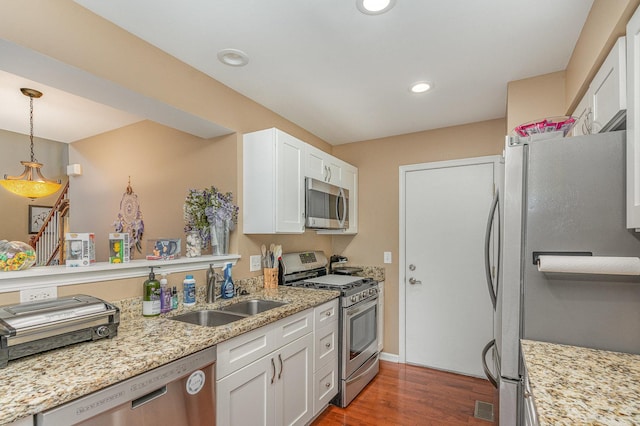 1966 Waverly Way, Montgomery, IL 60538 - kitchen featuring appliances with stainless steel finishes, a sink, wood finished floors, white cabinets, and pendant lighting