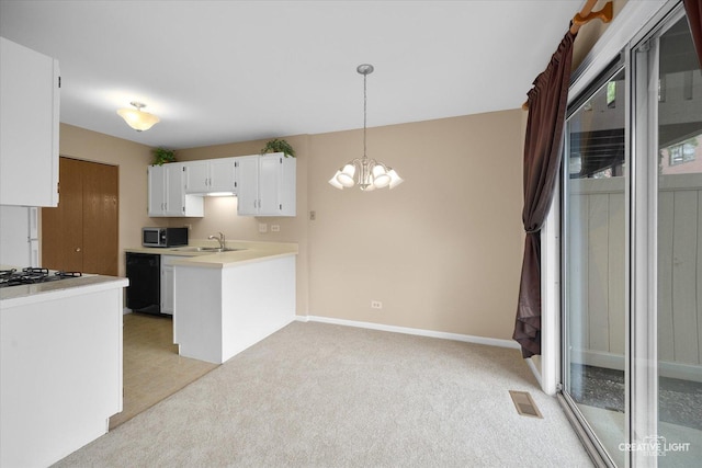 753 Candleridge Ct Unit C1, Bartlett, IL 60103 - kitchen with stainless steel microwave, a sink, light colored carpet, a chandelier, and white cabinetry