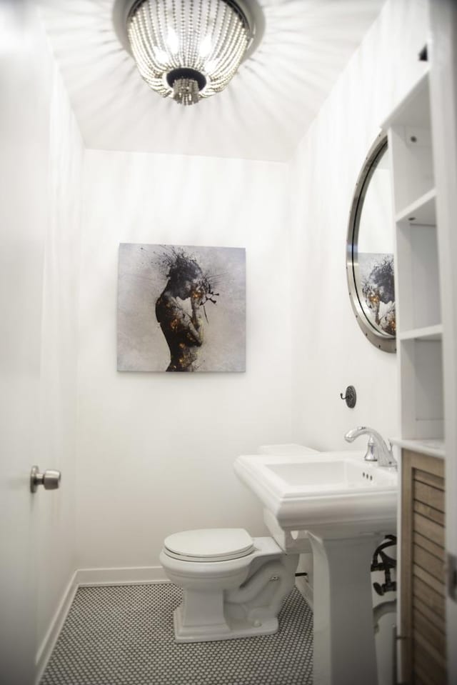 1703 Beverly Pl, Highland Park, IL 60035 - half bathroom with tile patterned floors, toilet, baseboards, and a chandelier