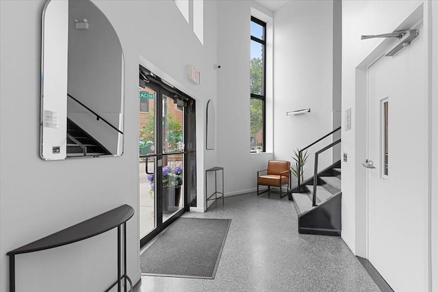 1201 W Wrightwood Ave Unit 13, Chicago, IL 60614 - entryway with healthy amount of natural light, a high ceiling, stairs, and speckle patterned floor