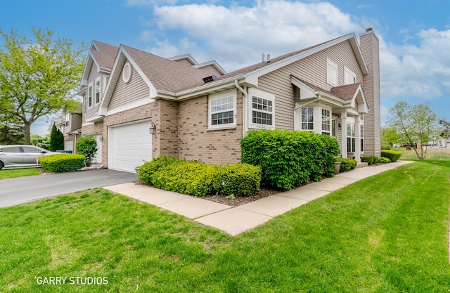 926 Willow St, Itasca, IL 60143 - view of side of home with driveway, a chimney, a garage, brick siding, and a lawn