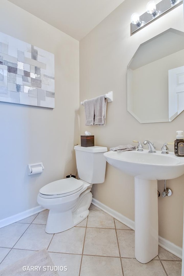 926 Willow St, Itasca, IL 60143 - half bathroom featuring toilet, tile patterned floors, baseboards, and a sink