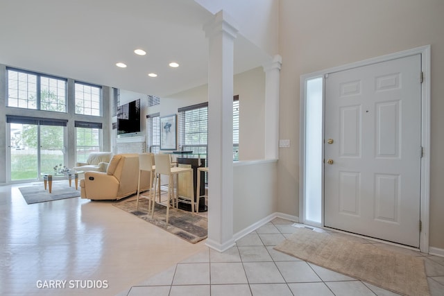 926 Willow St, Itasca, IL 60143 - tiled foyer entrance with decorative columns, recessed lighting, baseboards, and a high ceiling