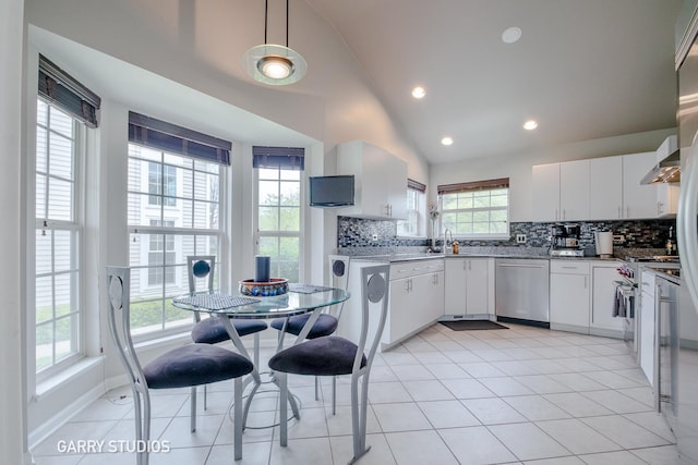 926 Willow St, Itasca, IL 60143 - kitchen with stainless steel appliances, lofted ceiling, decorative backsplash, a sink, and white cabinets
