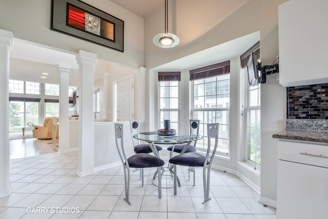 926 Willow St, Itasca, IL 60143 - dining area featuring ornate columns, baseboards, light tile patterned floors, and a high ceiling