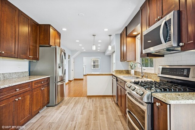 751 Essington Ln, Buffalo Grove, IL 60089 - kitchen featuring stainless steel appliances, a sink, light wood-type flooring, light stone countertops, and recessed lighting