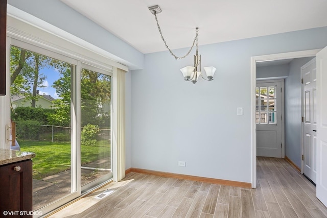 751 Essington Ln, Buffalo Grove, IL 60089 - unfurnished dining area with a chandelier, light wood finished floors, and baseboards
