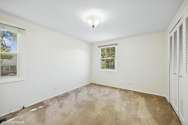 751 Essington Ln, Buffalo Grove, IL 60089 - unfurnished bedroom featuring a closet, carpet flooring, and multiple windows
