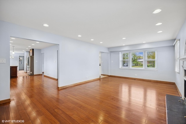 751 Essington Ln, Buffalo Grove, IL 60089 - unfurnished living room featuring a fireplace, wood finished floors, baseboards, and recessed lighting