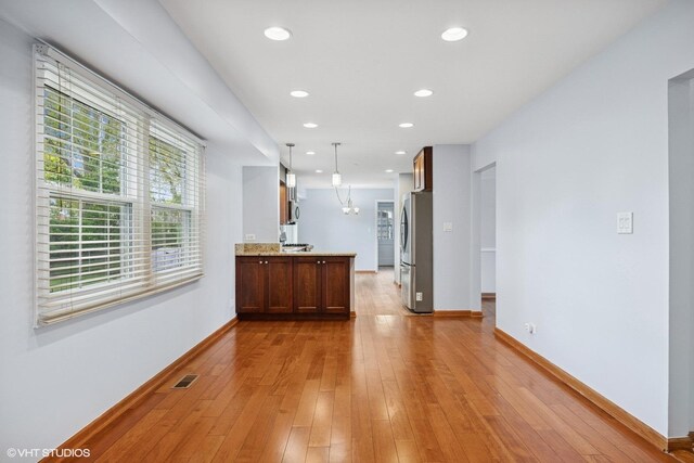 751 Essington Ln, Buffalo Grove, IL 60089 - kitchen with freestanding refrigerator, baseboards, light wood-style floors, recessed lighting, and hanging light fixtures