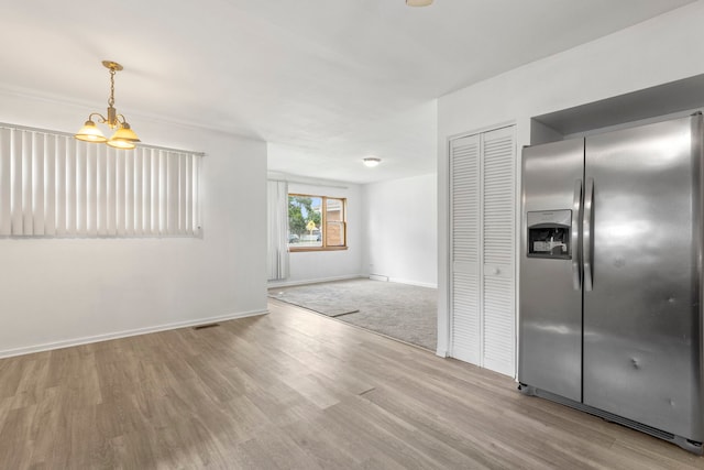 8639 Plainfield Rd, Lyons, IL 60534 - kitchen with stainless steel refrigerator with ice dispenser, wood finished floors, hanging light fixtures, and a chandelier