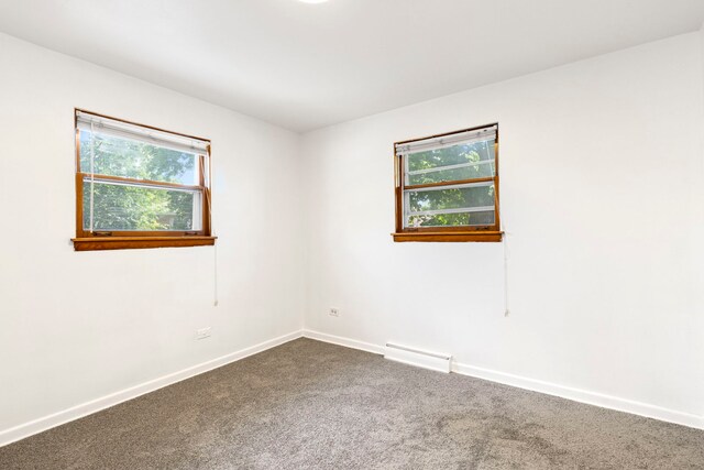 8639 Plainfield Rd, Lyons, IL 60534 - empty room featuring dark colored carpet and baseboards