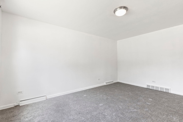 8639 Plainfield Rd, Lyons, IL 60534 - spare room featuring a baseboard heating unit and dark colored carpet