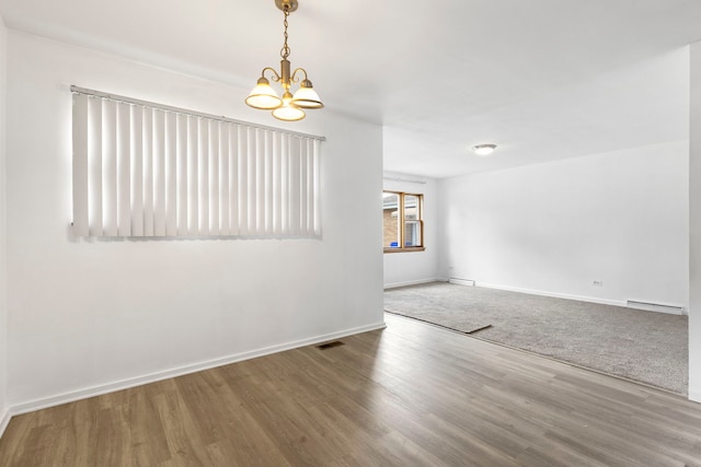 8639 Plainfield Rd, Lyons, IL 60534 - spare room featuring baseboard heating, a chandelier, and wood finished floors