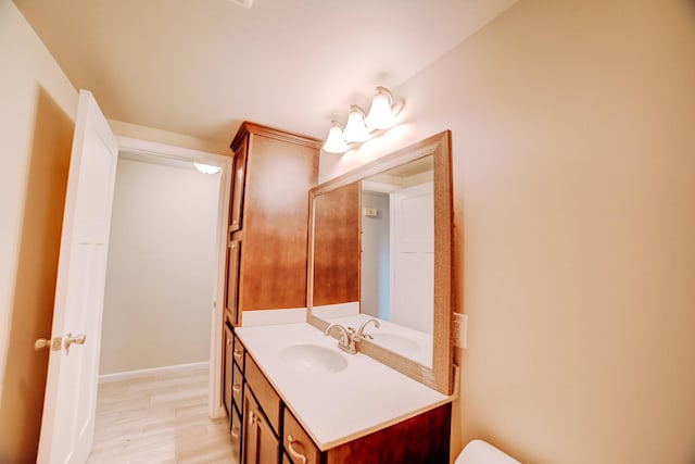 302 E Cherry St Unit B, Watseka, IL 60970 - half bath featuring vanity, baseboards, and toilet