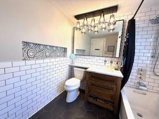 1010 N Patton Ave, Arlington Heights, IL 60004 - bathroom featuring tile walls, toilet, vanity, tile patterned floors, and a chandelier