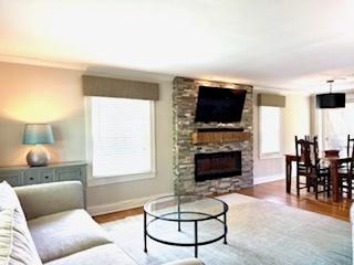 1010 N Patton Ave, Arlington Heights, IL 60004 - living area with baseboards, a stone fireplace, and wood finished floors