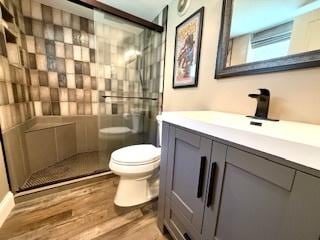1010 N Patton Ave, Arlington Heights, IL 60004 - bathroom with vanity, toilet, a shower stall, and wood finished floors