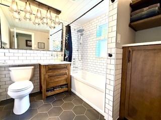 1010 N Patton Ave, Arlington Heights, IL 60004 - bathroom featuring toilet, shower / tub combo with curtain, a chandelier, vanity, and tile patterned floors