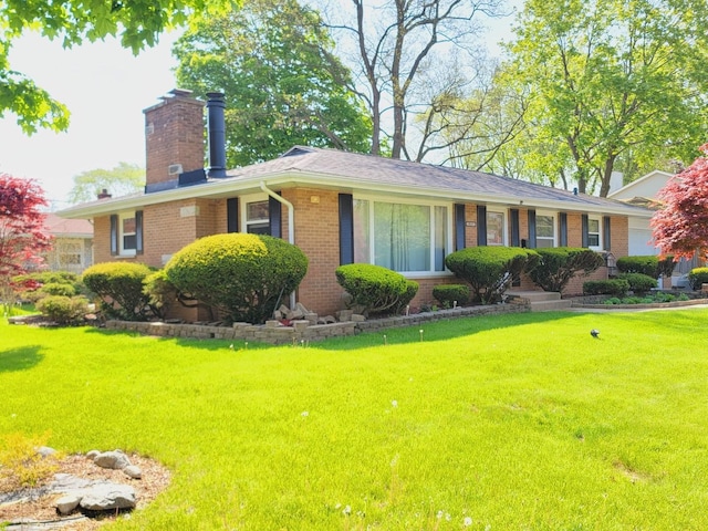 511 N Berwick Blvd, Waukegan, IL 60085 - ranch-style home with a chimney, brick siding, and a front lawn