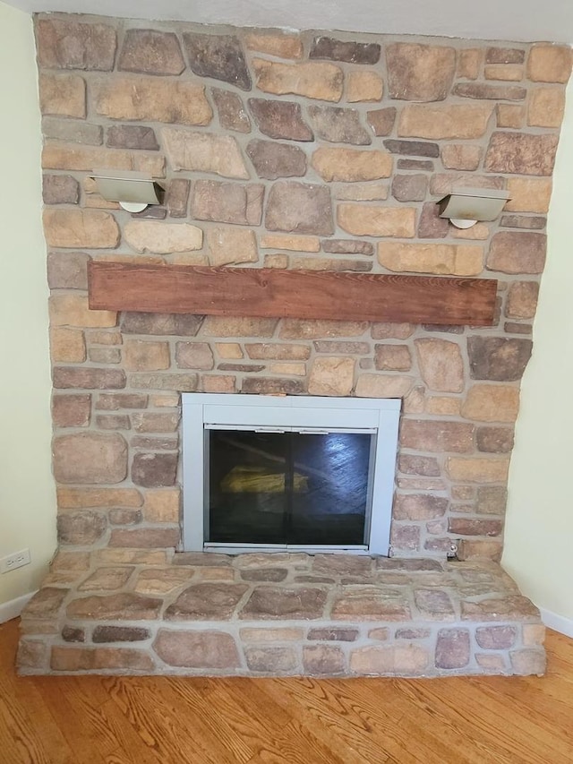 511 N Berwick Blvd, Waukegan, IL 60085 - detailed view of baseboards, wood finished floors, and a fireplace
