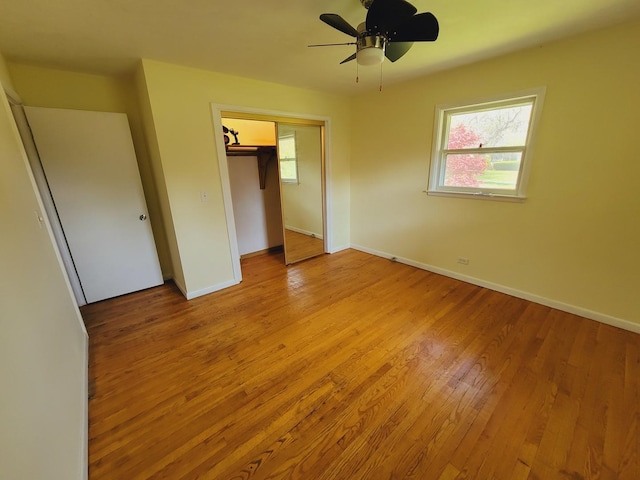 511 N Berwick Blvd, Waukegan, IL 60085 - unfurnished bedroom featuring a closet, baseboards, light wood-style floors, and a ceiling fan