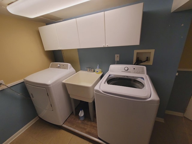 511 N Berwick Blvd, Waukegan, IL 60085 - laundry area with washing machine and dryer, cabinet space, baseboards, and light tile patterned floors