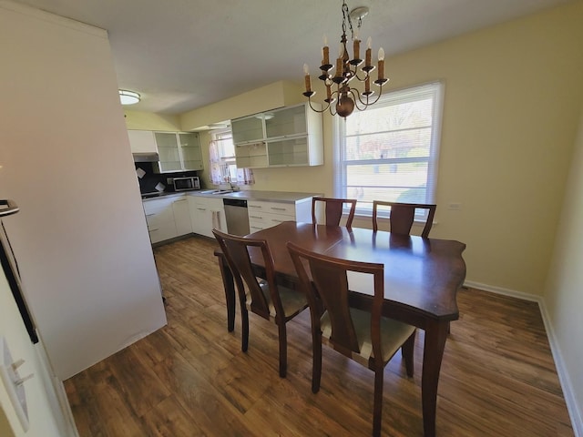 511 N Berwick Blvd, Waukegan, IL 60085 - dining space with dark wood finished floors, a chandelier, and baseboards