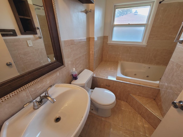 511 N Berwick Blvd, Waukegan, IL 60085 - full bath with a sink, a whirlpool tub, tile walls, tile patterned flooring, and toilet