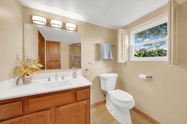 bathroom featuring toilet, baseboards, a shower stall, tile patterned flooring, and vanity