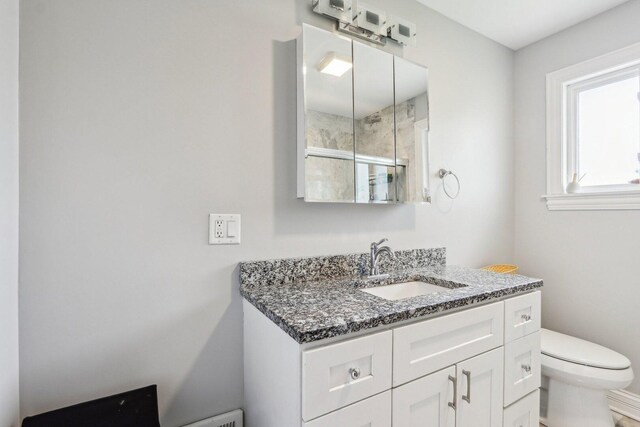 9017 Pottawattami Dr, Skokie, IL 60076 - bathroom featuring toilet, vanity, and a shower