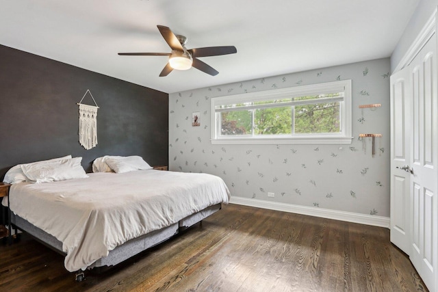 9017 Pottawattami Dr, Skokie, IL 60076 - bedroom featuring wood finished floors, a closet, baseboards, wallpapered walls, and ceiling fan