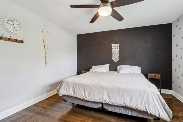 9017 Pottawattami Dr, Skokie, IL 60076 - bedroom with wood finished floors, baseboards, an accent wall, and a ceiling fan