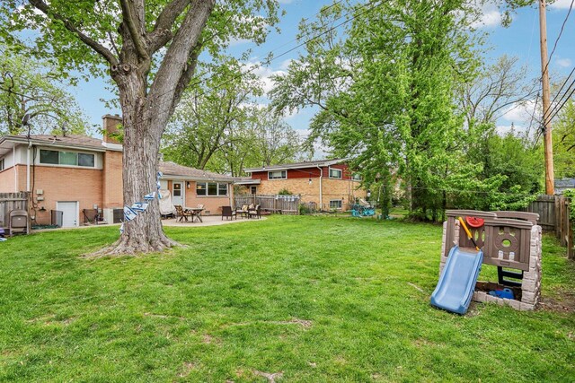9017 Pottawattami Dr, Skokie, IL 60076 - view of yard featuring a patio area and central air condition unit