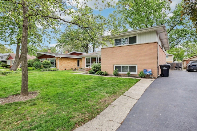 9017 Pottawattami Dr, Skokie, IL 60076 - tri-level home with brick siding, driveway, and a front yard