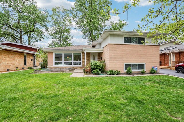 9017 Pottawattami Dr, Skokie, IL 60076 - split level home featuring brick siding and a front lawn