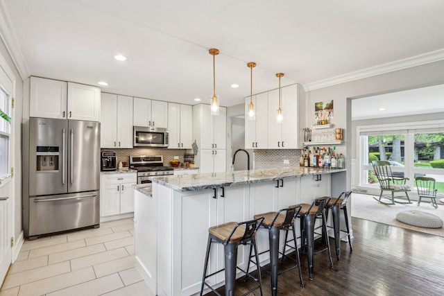 9017 Pottawattami Dr, Skokie, IL 60076 - kitchen featuring stainless steel appliances, ornamental molding, a peninsula, backsplash, and a kitchen breakfast bar