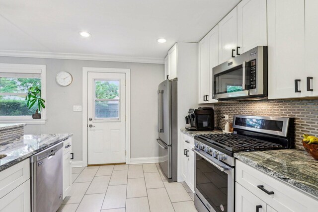 9017 Pottawattami Dr, Skokie, IL 60076 - kitchen with appliances with stainless steel finishes, plenty of natural light, baseboards, light stone countertops, and crown molding