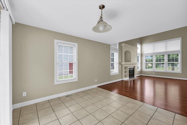1208 Waters Edge Rd, Champaign, IL 61822 - unfurnished living room featuring light tile patterned flooring and a fireplace