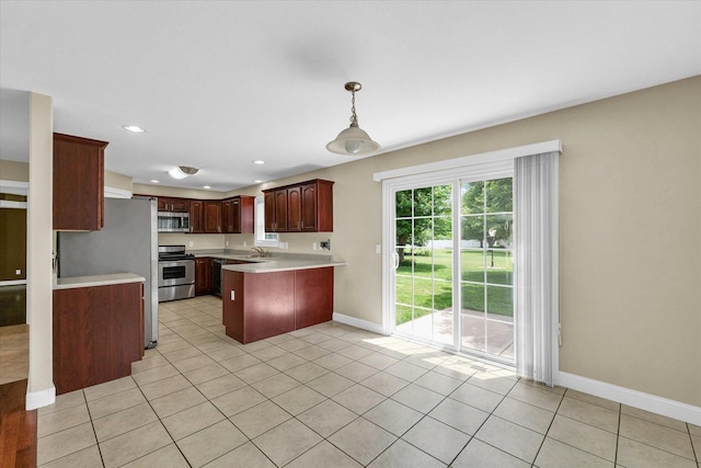 1208 Waters Edge Rd, Champaign, IL 61822 - kitchen with stainless steel appliances, a peninsula, light countertops, light tile patterned flooring, and recessed lighting