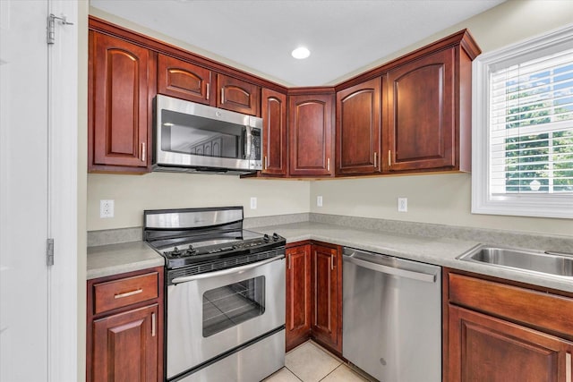1208 Waters Edge Rd, Champaign, IL 61822 - kitchen with appliances with stainless steel finishes, light countertops, light tile patterned floors, and recessed lighting