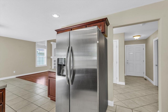 1208 Waters Edge Rd, Champaign, IL 61822 - kitchen featuring stainless steel fridge with ice dispenser, light tile patterned floors, recessed lighting, and light countertops
