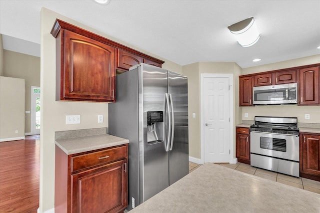 1208 Waters Edge Rd, Champaign, IL 61822 - kitchen with appliances with stainless steel finishes, light countertops, recessed lighting, and light tile patterned floors