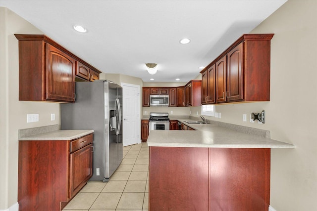 1208 Waters Edge Rd, Champaign, IL 61822 - kitchen featuring stainless steel appliances, a peninsula, recessed lighting, light tile patterned floors, and light countertops