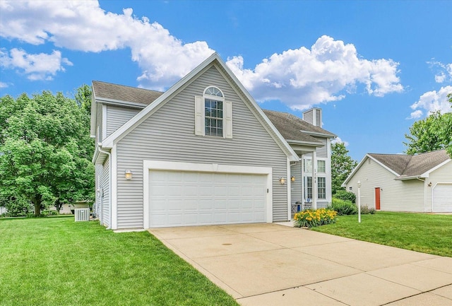 1208 Waters Edge Rd, Champaign, IL 61822 - traditional home featuring a front lawn, a garage, driveway, and a chimney