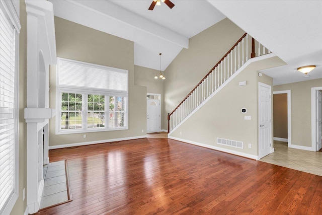 1208 Waters Edge Rd, Champaign, IL 61822 - unfurnished living room featuring hardwood / wood-style flooring, a ceiling fan, stairs, and high vaulted ceiling