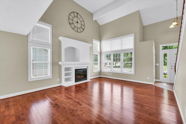 1208 Waters Edge Rd, Champaign, IL 61822 - unfurnished living room featuring high vaulted ceiling, healthy amount of natural light, hardwood / wood-style flooring, and a fireplace with flush hearth