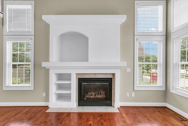 1208 Waters Edge Rd, Champaign, IL 61822 - detailed view of wood finished floors, built in shelves, and a tiled fireplace