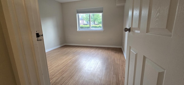 9356 Bay Colony Dr Unit 1S, Des Plaines, IL 60016 - empty room featuring wood finished floors and baseboards