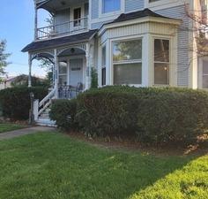 view of front of house with a balcony and a front yard